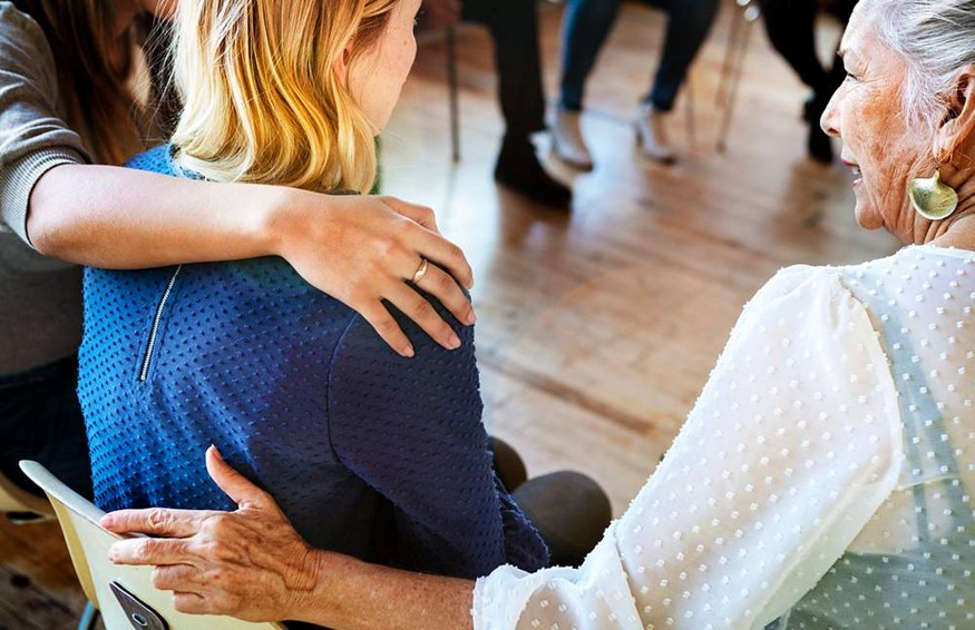 A person hugging another person